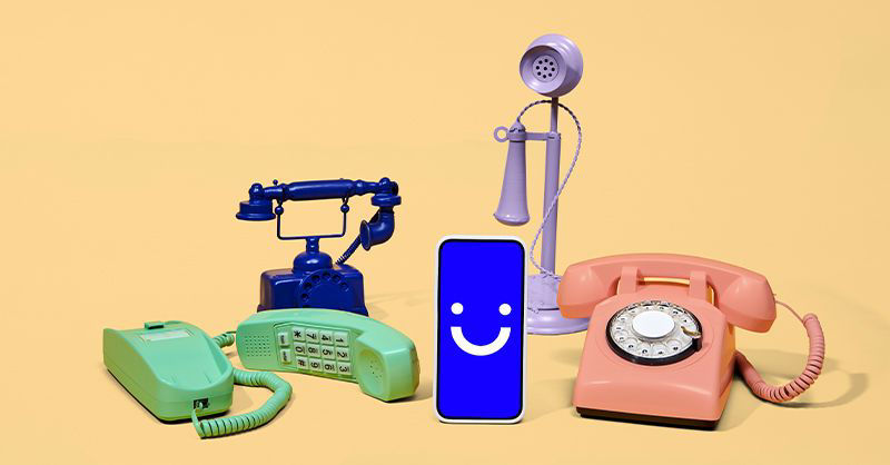 Visible cellphone next to old landline phones