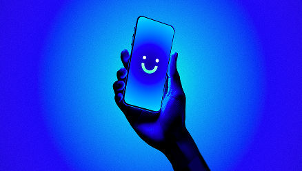 visible phone held in front of holiday lights