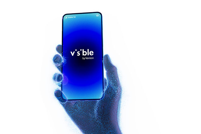 Phone with visible smiley emoji held in front of blue light