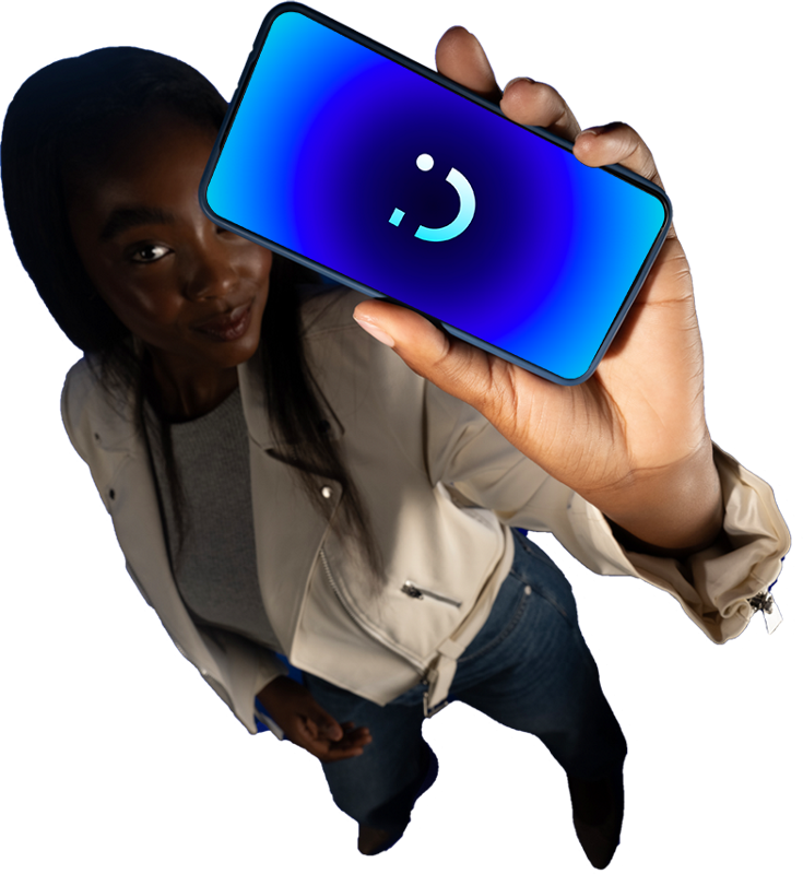 Phone with visible smiley emoji held in front of blue light