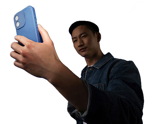 Phone with visible smiley emoji held in front of blue light