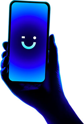 Phone with visible smiley emoji held in front of blue light