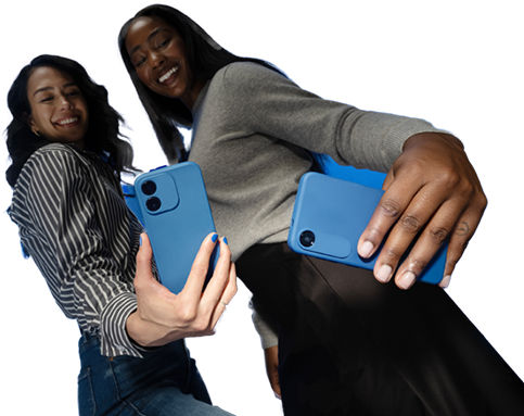Phone with visible smiley emoji held in front of blue light