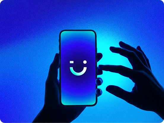 smiling woman pointing to visible phone