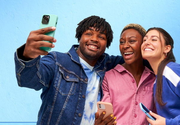 friends taking a selfie in front of a blue wall