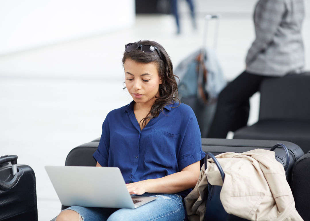 A woman using a laptop at an airport