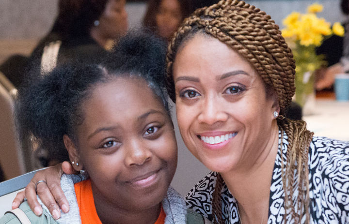 Woman and girl smiling at the camera