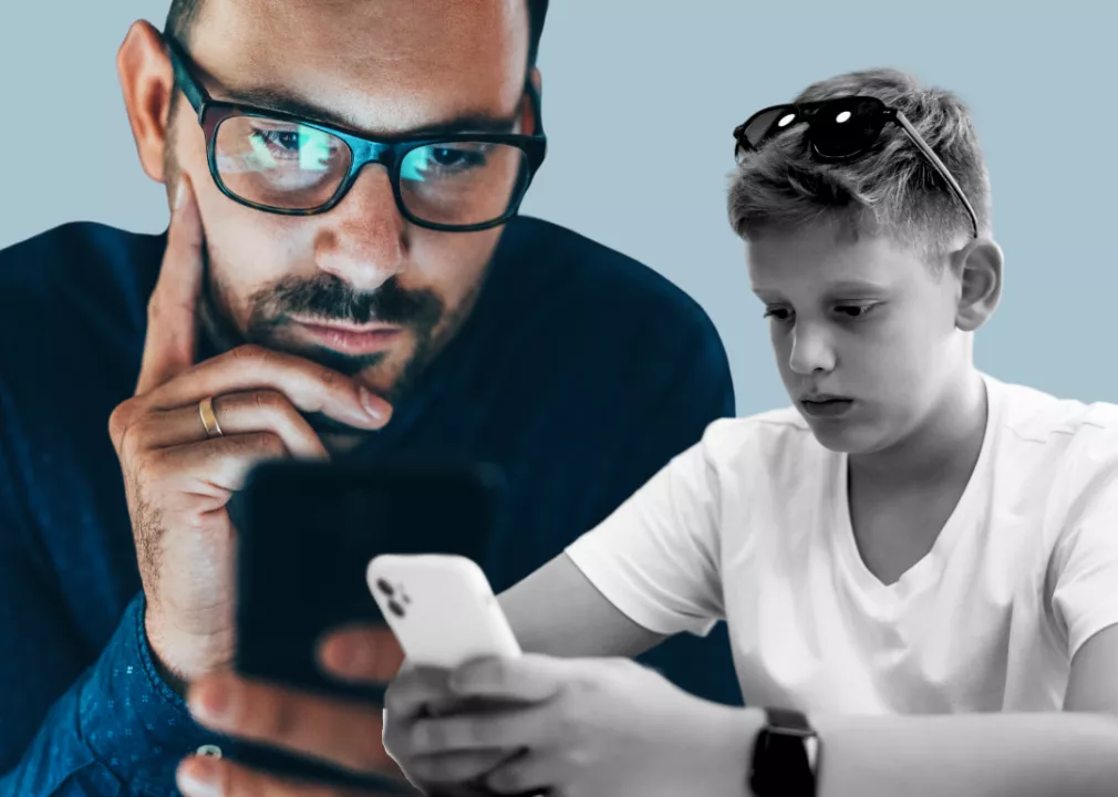 man and teenager looking at their smartphones